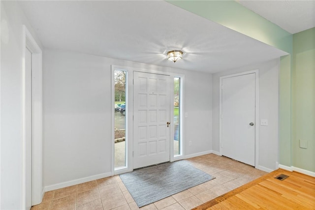 tiled foyer with baseboards