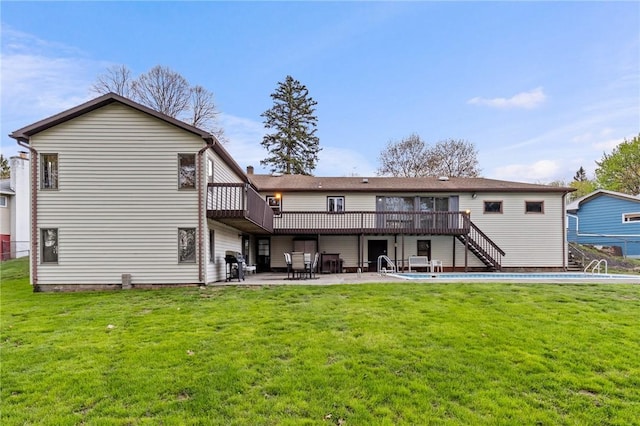 back of house with a lawn, a wooden deck, stairs, and a patio area
