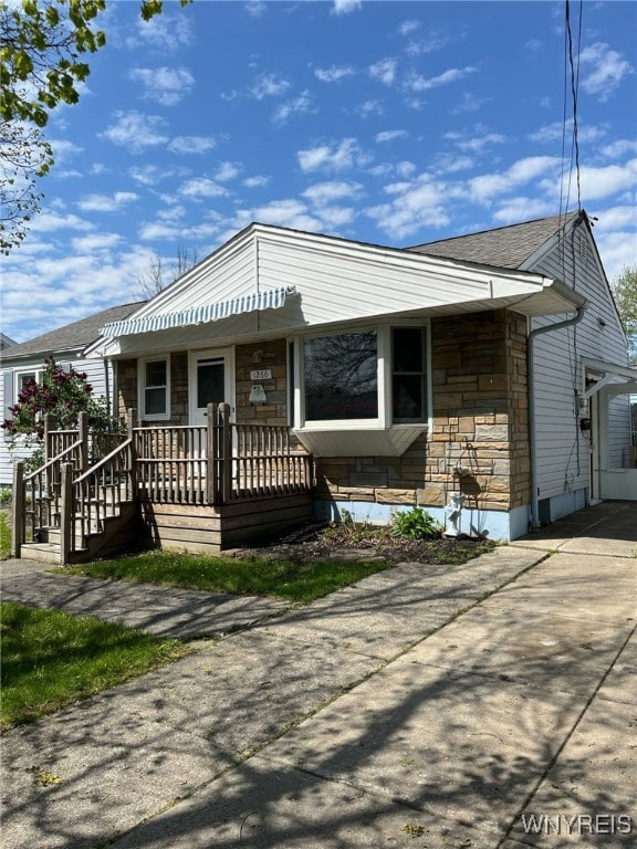 1266 91st St, Niagara Falls, NY 14304 - view of front of house featuring stone siding and a porch