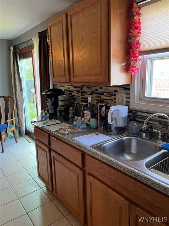 1266 91st St, Niagara Falls, NY 14304 - kitchen with healthy amount of natural light, tasteful backsplash, a sink, and light tile patterned flooring
