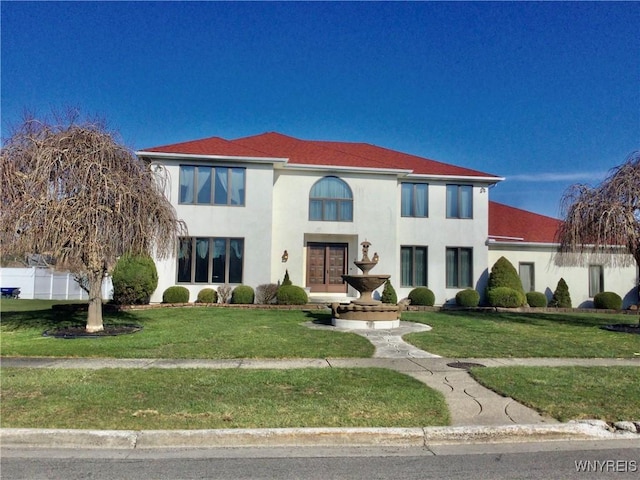 mediterranean / spanish-style home with stucco siding and a front yard