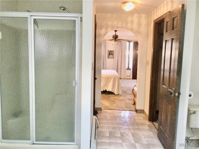 bathroom featuring a ceiling fan, a shower stall, toilet, and connected bathroom