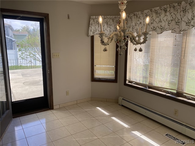 unfurnished dining area featuring light tile patterned flooring and a baseboard radiator