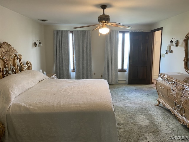 carpeted bedroom with ceiling fan, visible vents, and a baseboard radiator