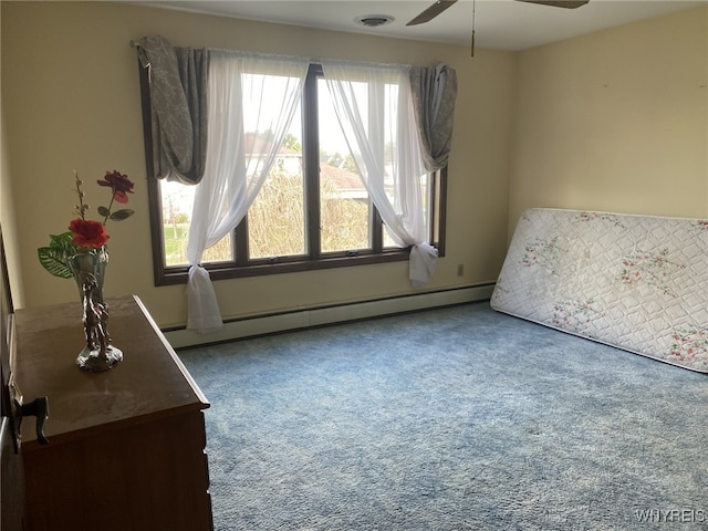 carpeted bedroom featuring a ceiling fan, a baseboard heating unit, multiple windows, and visible vents