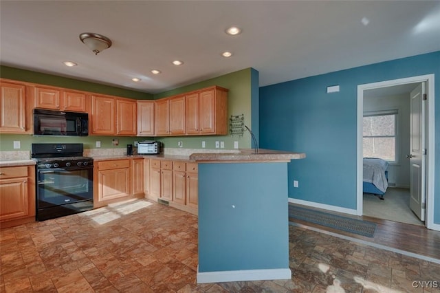 46139 County Route 191, Orleans, NY 13640 - kitchen featuring stone finish floor, light brown cabinetry, light countertops, black appliances, and a peninsula
