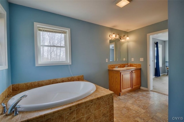 46139 County Route 191, Orleans, NY 13640 - full bath featuring a garden tub, baseboards, stone finish floor, and vanity