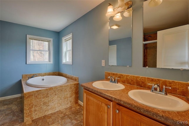 46139 County Route 191, Orleans, NY 13640 - bathroom featuring baseboards, a sink, and a garden tub