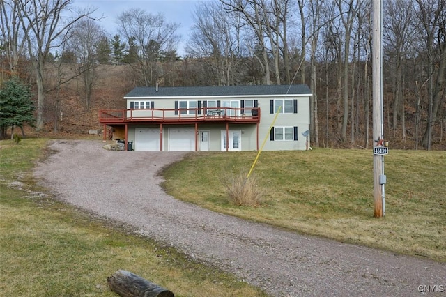 46139 County Route 191, Orleans, NY 13640 - view of front of property with an attached garage, a deck, a front lawn, and gravel driveway