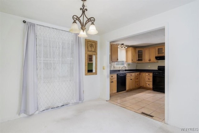 kitchen featuring dark countertops, black dishwasher, under cabinet range hood, a chandelier, and range with gas cooktop