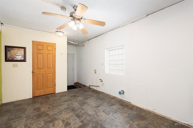 empty room with stone finish floor and a ceiling fan