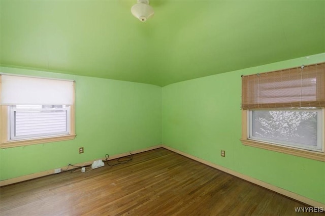 empty room featuring baseboards and wood finished floors