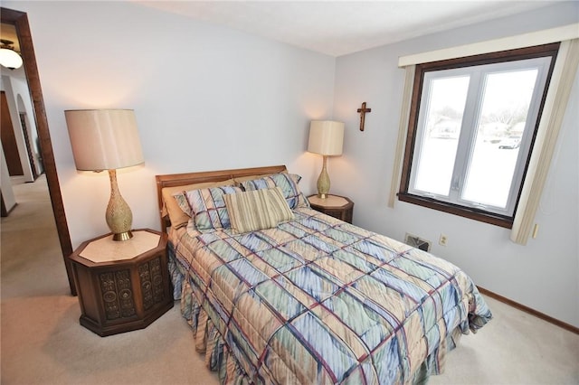 bedroom featuring baseboards and carpet