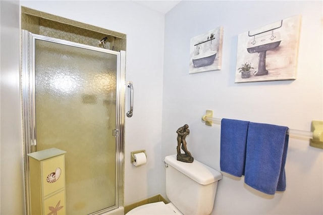 full bathroom featuring a shower stall and toilet