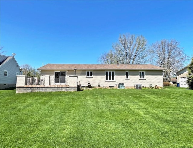 rear view of property featuring a yard