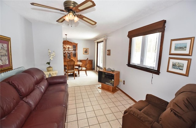 living area with light carpet and ceiling fan with notable chandelier