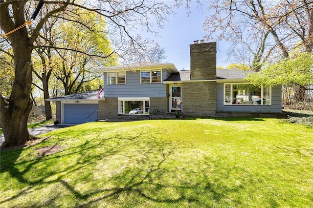 21 Cobb Ter, Brighton, NY 14620 - rear view of property featuring a lawn, an attached garage, a chimney, and stone siding