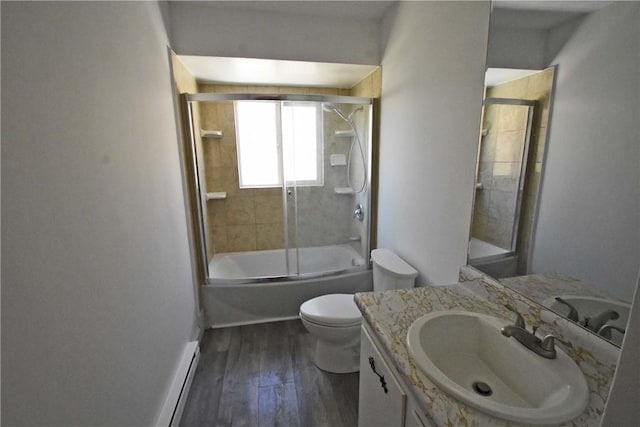 150 Monroe Dr, Horseheads, NY 14845 - bathroom with vanity, toilet, baseboards, wood finished floors, and bath / shower combo with glass door