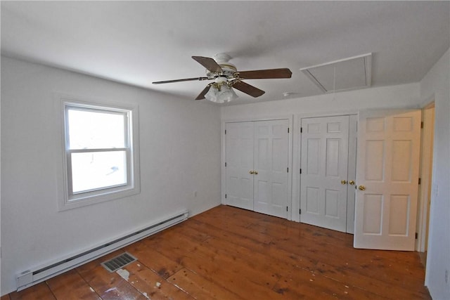150 Monroe Dr, Horseheads, NY 14845 - unfurnished bedroom featuring attic access, two closets, a ceiling fan, a baseboard heating unit, and hardwood / wood-style flooring