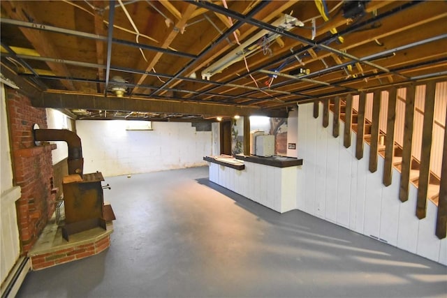 150 Monroe Dr, Horseheads, NY 14845 - unfinished basement featuring a wood stove, electric panel, and stairway