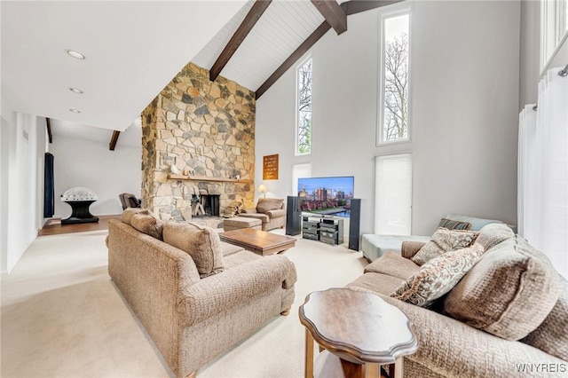 living area featuring a fireplace, high vaulted ceiling, beamed ceiling, and carpet floors