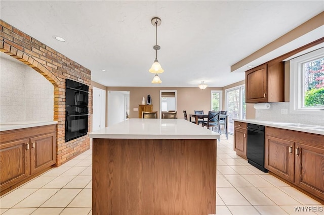 kitchen with plenty of natural light, light countertops, and light tile patterned floors