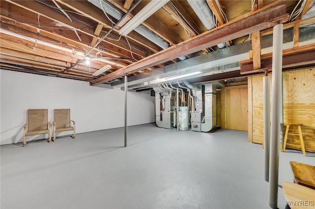 unfinished below grade area featuring heating unit and water heater