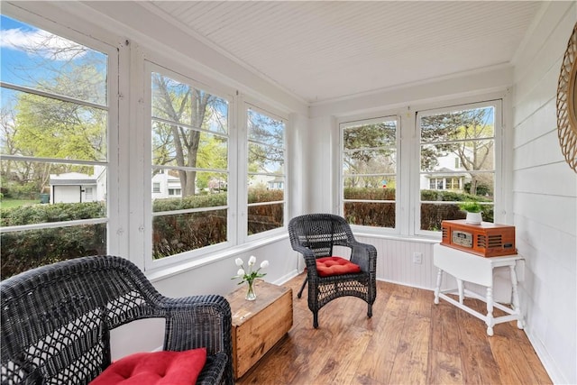 sunroom with ornamental molding and hardwood / wood-style flooring