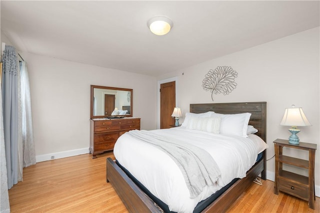 bedroom with baseboards and light wood finished floors