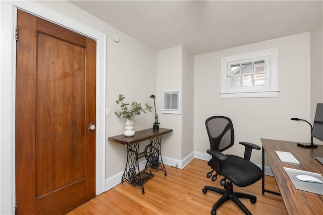 office featuring baseboards, wood finished floors, and visible vents