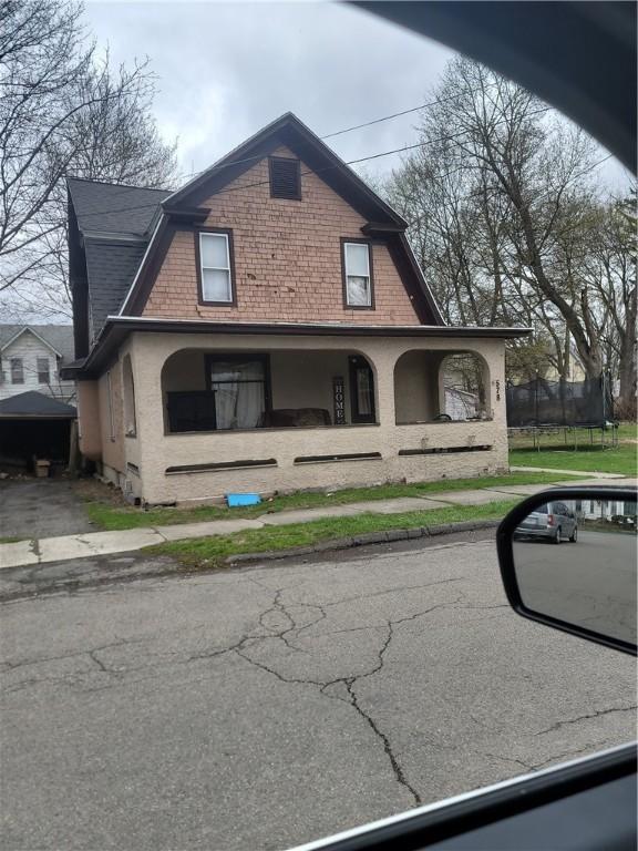 exterior space featuring a trampoline and a gambrel roof