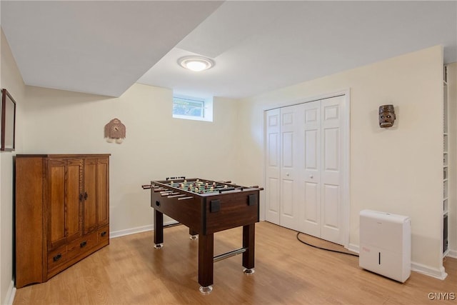 playroom with baseboards and light wood-style floors