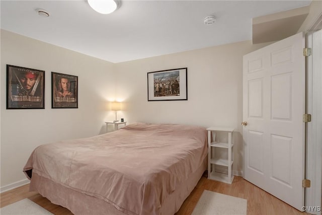 bedroom with light wood-style floors and baseboards