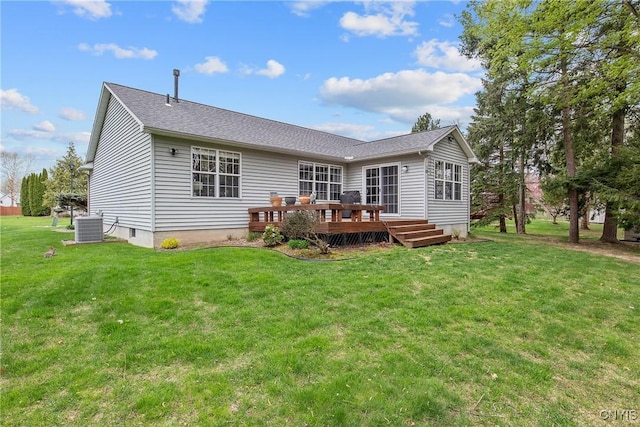 back of property with a yard, a deck, cooling unit, and a shingled roof