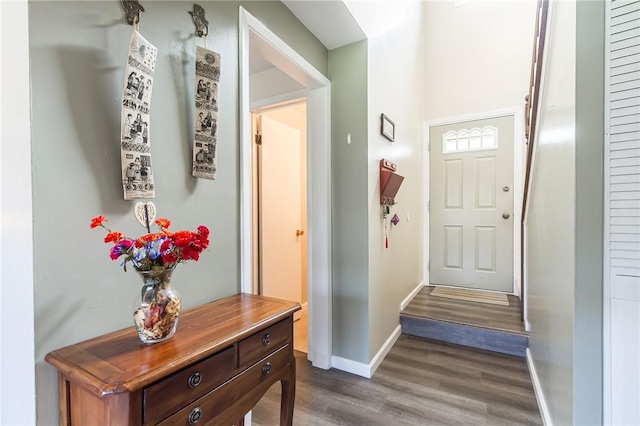 entryway featuring baseboards and dark wood finished floors
