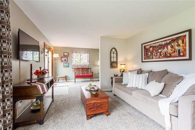 living area featuring carpet floors and baseboards