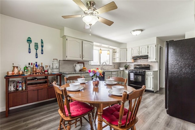 dining area with ceiling fan and wood finished floors