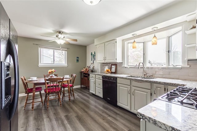 kitchen featuring decorative backsplash, a sink, refrigerator with ice dispenser, black dishwasher, and dark wood-type flooring