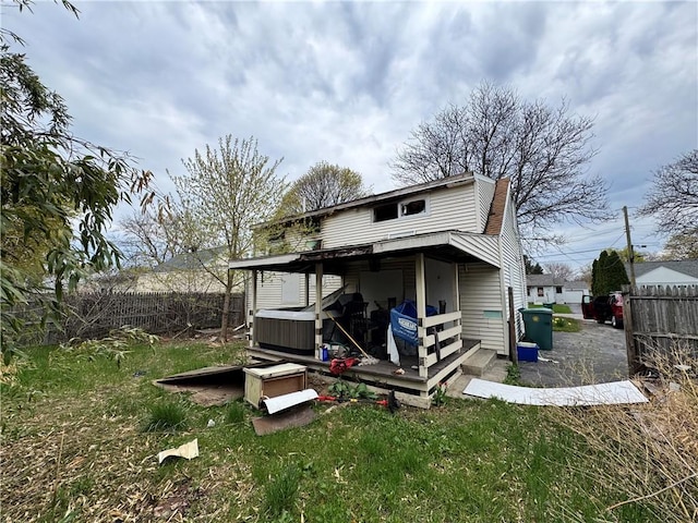 rear view of property with a lawn, a fenced backyard, and a deck
