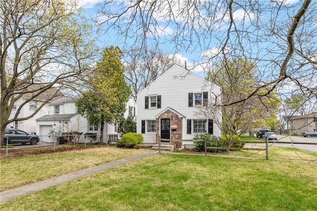 traditional-style home featuring fence and a front yard