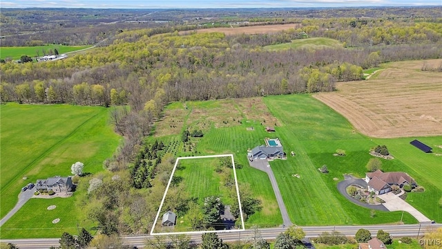drone / aerial view featuring a rural view and a forest view