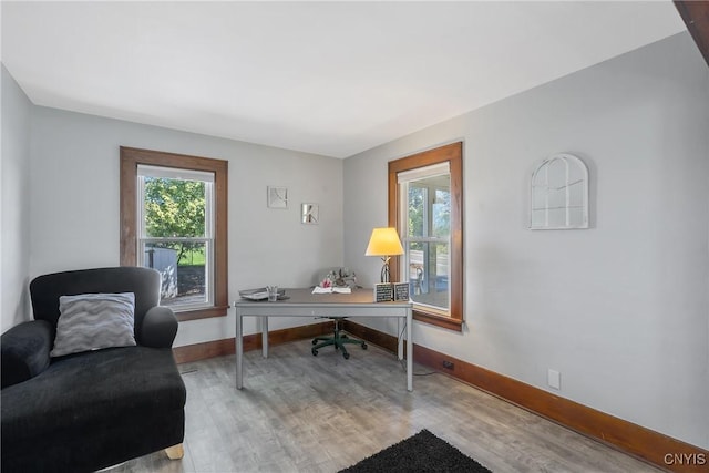 home office featuring baseboards and wood finished floors