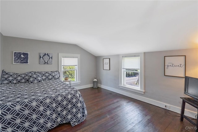 bedroom featuring baseboards, dark wood-style flooring, and lofted ceiling