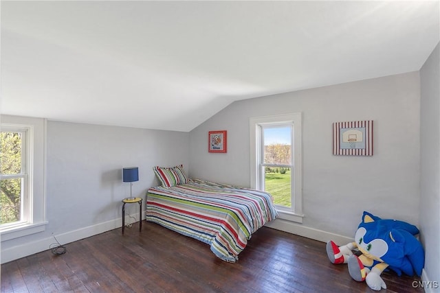 bedroom featuring baseboards, hardwood / wood-style flooring, and lofted ceiling