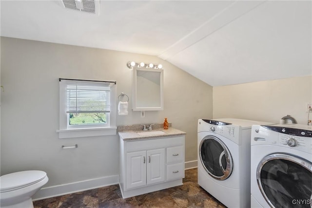 laundry room with washer and dryer, laundry area, a sink, baseboards, and visible vents