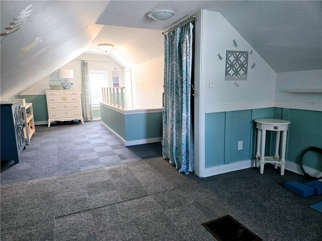 bonus room featuring visible vents, carpet flooring, baseboards, and vaulted ceiling