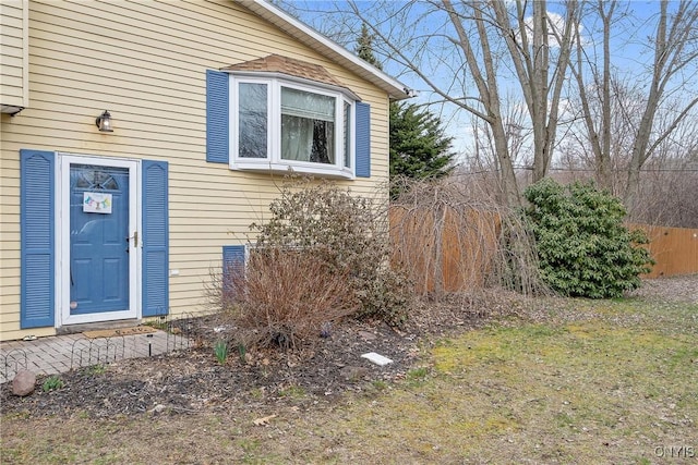 doorway to property featuring fence