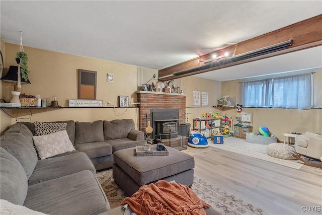 living area featuring wood finished floors and a wood stove