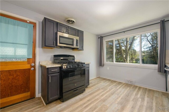 216 Pine Grove St, Syracuse, NY 13210 - kitchen featuring visible vents, light wood-style flooring, stainless steel microwave, and gas stove