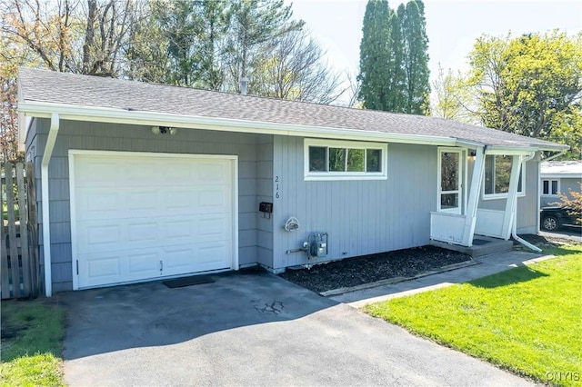 216 Pine Grove St, Syracuse, NY 13210 - view of front of house featuring an attached garage, roof with shingles, and aphalt driveway
